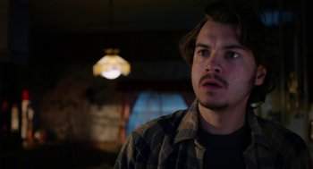 Movie still from “Killer Joe” (2011), directed by William Friedkin – A man with a beard is looking into the distance; Close Up shot, Over the shoulder angle