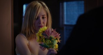 Movie still from “Killer Joe” (2011), directed by William Friedkin – A woman holding a bunch of flowers in her hands; Close Up shot, Over the shoulder angle