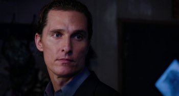 Movie still from “Killer Joe” (2011), directed by William Friedkin – A person wearing a suit and tie; Close Up shot, Over the shoulder angle