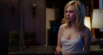 Movie still from “Killer Joe” (2011), directed by William Friedkin – A young woman holding a knife in her hand; Medium shot, Over the shoulder angle