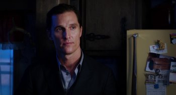 Movie still from “Killer Joe” (2011), directed by William Friedkin – A person wearing a suit and tie; Close Up shot, Over the shoulder angle