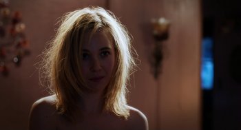 Movie still from “Killer Joe” (2011), directed by William Friedkin – A young woman with blonde hair is posing for the camera; Close Up shot, Over the shoulder angle