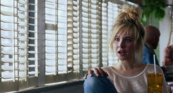 Movie still from “Killer Joe” (2011), directed by William Friedkin – A woman with a messy hair bun sitting in front of a window; Close Up shot, Over the shoulder angle