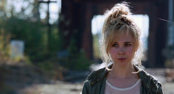 Movie still from “Killer Joe” (2011), directed by William Friedkin – A young woman with blonde hair is standing outside; Close Up shot, Over the shoulder angle
