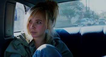 Movie still from “Killer Joe” (2011), directed by William Friedkin – A woman sitting in the back seat of a car; Close Up shot, High angle