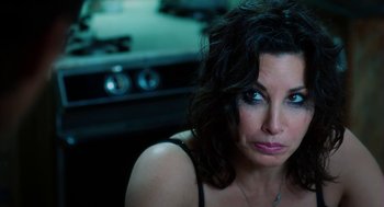 Movie still from “Killer Joe” (2011), directed by William Friedkin – A person sitting in front of a stove; Close Up shot, High angle