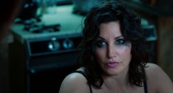 Movie still from “Killer Joe” (2011), directed by William Friedkin – A person wearing a necklace; Close Up shot, High angle