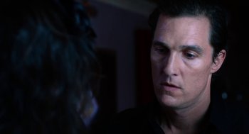Movie still from “Killer Joe” (2011), directed by William Friedkin – A person looking at a camera; Close Up shot, Over the shoulder angle