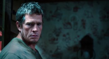 Movie still from “Killer Joe” (2011), directed by William Friedkin – A person wearing a green shirt; Close Up shot, Low angle