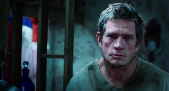 Movie still from “Killer Joe” (2011), directed by William Friedkin – A person wearing a green t - shirt; Close Up shot, Low angle