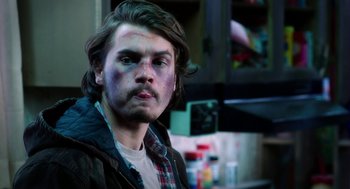 Movie still from “Killer Joe” (2011), directed by William Friedkin – A young man with blue and purple makeup on his face; Close Up shot, Over the shoulder angle