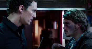 Movie still from “Killer Joe” (2011), directed by William Friedkin – A man and a boy are facing each other; Close Up shot, Over the shoulder angle