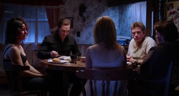 Movie still from “Killer Joe” (2011), directed by William Friedkin – A group of people sitting around a table; Medium shot, Over the shoulder angle