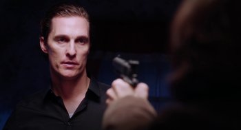 Movie still from “Killer Joe” (2011), directed by William Friedkin – A man holding a gun in front of a mirror; Close Up shot, Over the shoulder angle