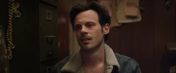 Movie still from “Killing Them Softly” (2012), directed by Andrew Dominik – A person wearing a jacket; Close Up shot, Over the shoulder angle