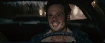 Movie still from “Killing Them Softly” (2012), directed by Andrew Dominik – A man sitting in the drivers seat of a car; Close Up shot, Over the shoulder angle