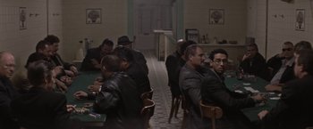 Movie still from “Killing Them Softly” (2012), directed by Andrew Dominik – A group of men sitting at a table in a room; Wide shot, High angle