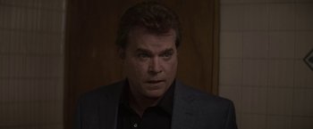 Movie still from “Killing Them Softly” (2012), directed by Andrew Dominik – A person wearing a suit and tie; Close Up shot, Over the shoulder angle