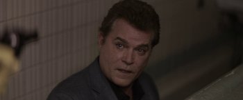 Movie still from “Killing Them Softly” (2012), directed by Andrew Dominik – A person wearing a suit and tie; Close Up shot, Over the shoulder angle