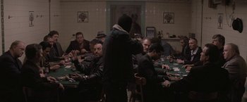 Movie still from “Killing Them Softly” (2012), directed by Andrew Dominik – A group of people sitting at a table with cards; Wide shot, High angle