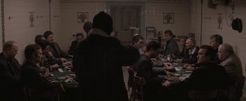 Movie still from “Killing Them Softly” (2012), directed by Andrew Dominik – A group of people sitting around a table; Wide shot, Over the shoulder angle