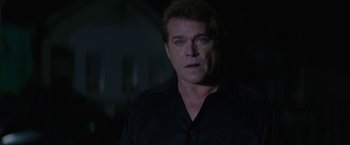 Movie still from “Killing Them Softly” (2012), directed by Andrew Dominik – A person wearing a black shirt; Close Up shot, Over the shoulder angle