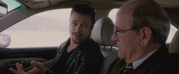 Movie still from “Killing Them Softly” (2012), directed by Andrew Dominik – Two men sitting in the back seat of a car; Close Up shot, Over the shoulder angle
