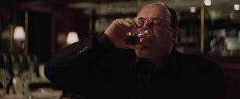 Movie still from “Killing Them Softly” (2012), directed by Andrew Dominik – A man drinking a glass of wine from a wine bottle; Close Up shot, Low angle