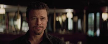 Movie still from “Killing Them Softly” (2012), directed by Andrew Dominik – A person wearing a black shirt; Close Up shot, Over the shoulder angle
