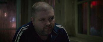 Movie still from “Killing Them Softly” (2012), directed by Andrew Dominik – A person with a beard; Close Up shot, Over the shoulder angle