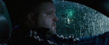 Movie still from “Killing Them Softly” (2012), directed by Andrew Dominik – A person in a car; Close Up shot, Low angle