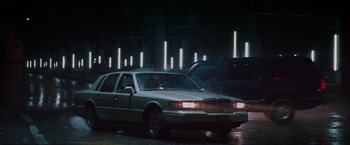 Movie still from “Killing Them Softly” (2012), directed by Andrew Dominik – A car that is parked on the side of the road; Wide shot, Low angle