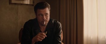 Movie still from “Killing Them Softly” (2012), directed by Andrew Dominik – A man smoking a cigarette while wearing a leather jacket; Close Up shot, Over the shoulder angle