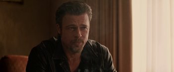 Movie still from “Killing Them Softly” (2012), directed by Andrew Dominik – A person wearing a leather jacket; Close Up shot, Over the shoulder angle