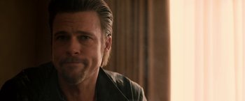 Movie still from “Killing Them Softly” (2012), directed by Andrew Dominik – A person wearing a jacket; Close Up shot, Over the shoulder angle