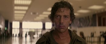 Movie still from “Killing Them Softly” (2012), directed by Andrew Dominik – A person wearing a hooded sweatshirt; Close Up shot, Low angle