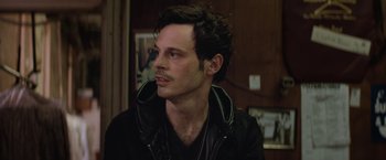 Movie still from “Killing Them Softly” (2012), directed by Andrew Dominik – A person wearing a black jacket; Close Up shot, Over the shoulder angle