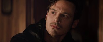 Movie still from “Killing Them Softly” (2012), directed by Andrew Dominik – A person wearing a leather jacket; Close Up shot, Over the shoulder angle