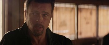 Movie still from “Killing Them Softly” (2012), directed by Andrew Dominik – A person wearing a black shirt; Close Up shot, Over the shoulder angle
