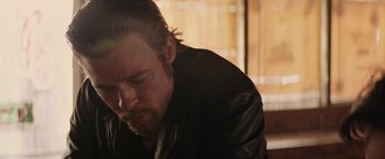 Movie still from “Killing Them Softly” (2012), directed by Andrew Dominik – A person wearing a leather jacket; Close Up shot, Low angle