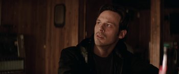 Movie still from “Killing Them Softly” (2012), directed by Andrew Dominik – A person wearing a black jacket; Close Up shot, Over the shoulder angle