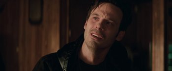 Movie still from “Killing Them Softly” (2012), directed by Andrew Dominik – A person wearing a black jacket; Close Up shot, Over the shoulder angle