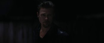 Movie still from “Killing Them Softly” (2012), directed by Andrew Dominik – A person wearing a black jacket; Close Up shot, Low angle