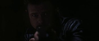 Movie still from “Killing Them Softly” (2012), directed by Andrew Dominik – A man taking a picture with a camera in the dark; Close Up shot, Low angle