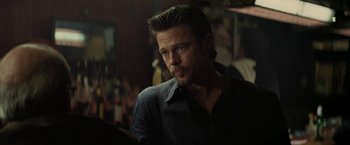 Movie still from “Killing Them Softly” (2012), directed by Andrew Dominik – A person wearing a black shirt; Close Up shot, Over the shoulder angle
