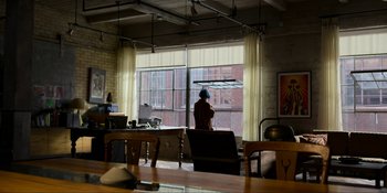 Movie still from “Kimi” (2022), directed by Steven Soderbergh – A person standing in front of a window in a living room; Extreme Wide shot, Over the shoulder angle