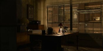 Movie still from “Kimi” (2022), directed by Steven Soderbergh – A desk in a room with a laptop on top of it; Wide shot, High angle