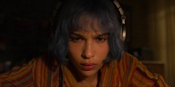 Movie still from “Kimi” (2022), directed by Steven Soderbergh – A woman with blue hair wearing headphones and looking at the camera; Close Up shot, Overhead angle
