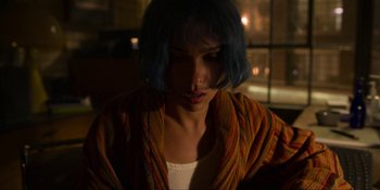 Movie still from “Kimi” (2022), directed by Steven Soderbergh – A woman with blue hair looking down at her face; Close Up shot, Over the shoulder angle