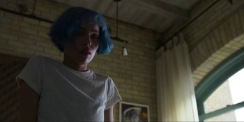 Movie still from “Kimi” (2022), directed by Steven Soderbergh – A person with blue hair standing in a room; Close Up shot, Low angle